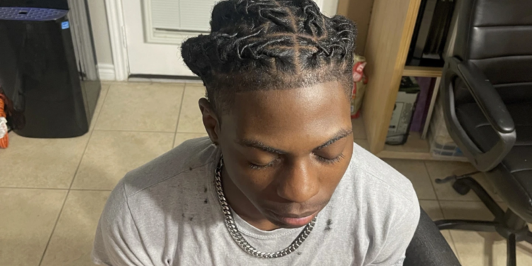 a black student was suspended for his hairstyle the school says it wasnt discrimination