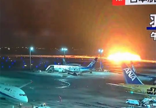 japan airlines plane in flames on the runway on tokyos haneda airport