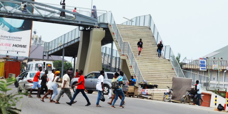 pedestrians carelessly abandon new tetegu footbridge dangerously cross highway