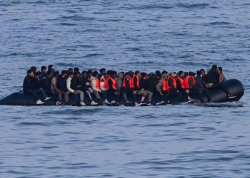 Germany to tighten people-smuggling law as chancellor visits UK