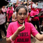 Hundreds of women with brooms join protests as Indonesia leader flies to China