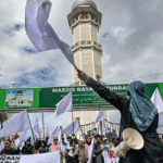 Indonesians raise white flags as anger grows over slow flood aid